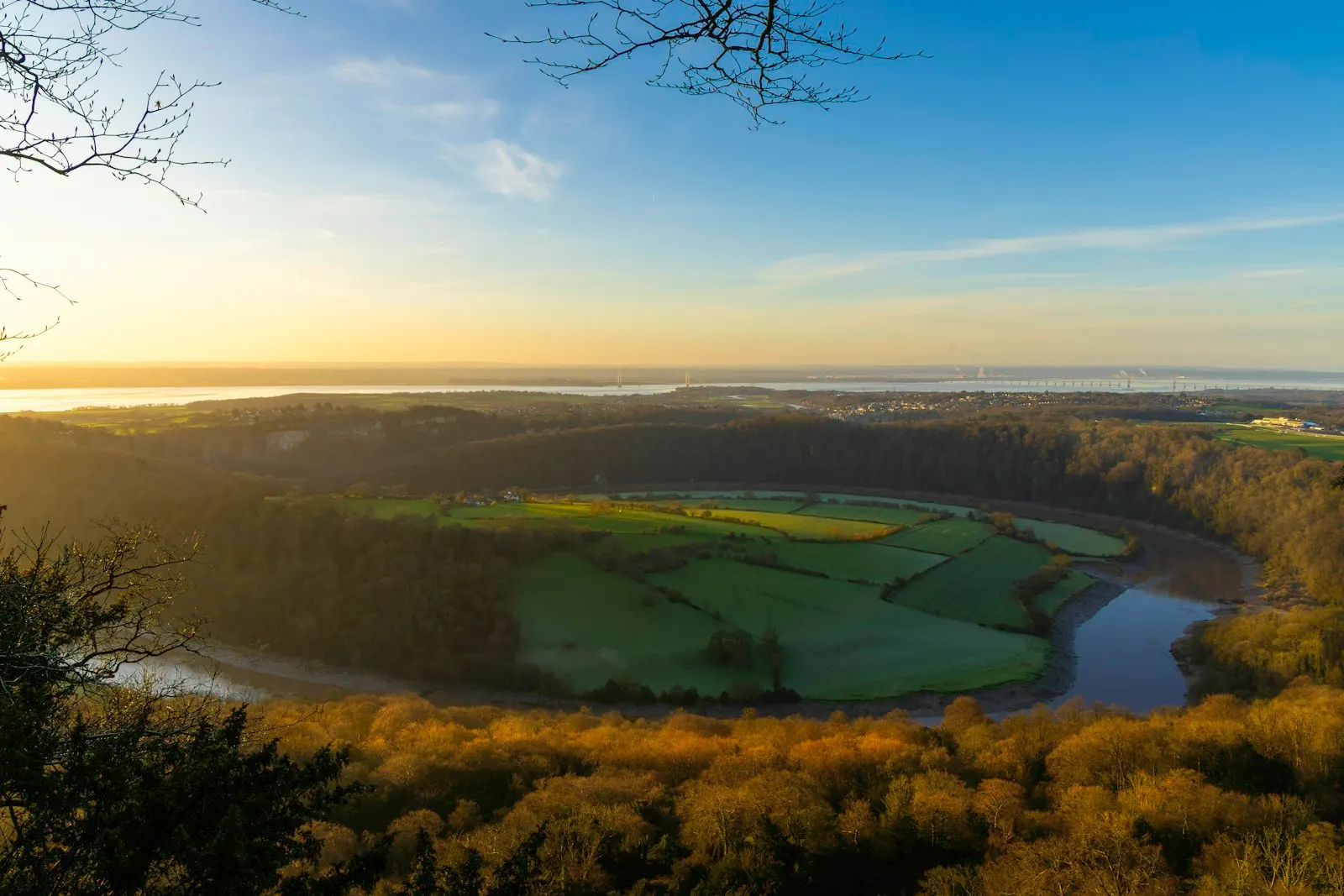 Lever du soleil sur une rivière sinueuse et des champs